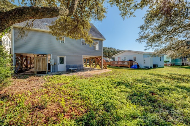 view of yard featuring a wooden deck and a patio