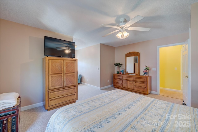 carpeted bedroom with a textured ceiling and ceiling fan