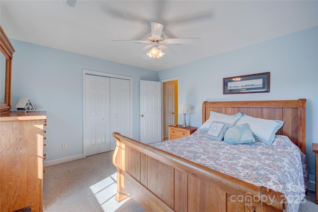 bedroom with light carpet, a closet, and ceiling fan