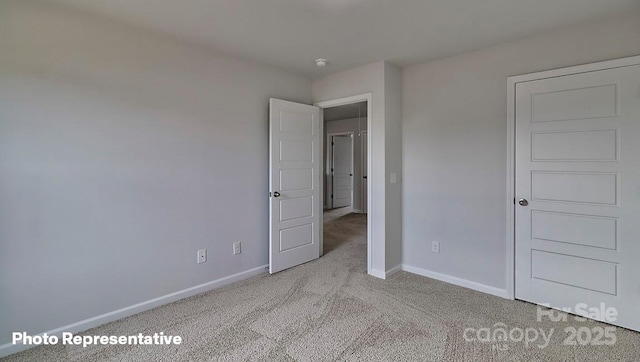 unfurnished bedroom featuring light carpet