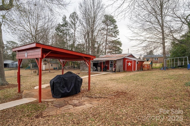 view of yard with a storage unit and a playground