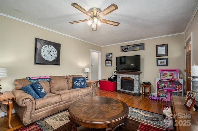 living room featuring hardwood / wood-style flooring, ornamental molding, and a textured ceiling