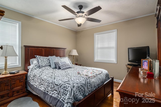 bedroom featuring dark wood-type flooring, ceiling fan, and crown molding