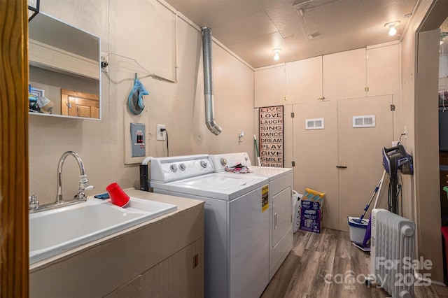 laundry room featuring sink, dark hardwood / wood-style flooring, and washing machine and dryer