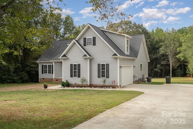 front of property featuring a garage, a front lawn, and central air condition unit