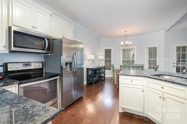 kitchen featuring dark hardwood / wood-style floors, white cabinetry, sink, ornamental molding, and stainless steel appliances