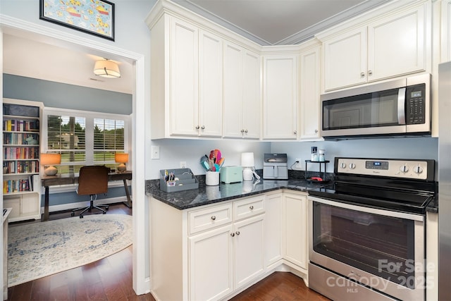 kitchen featuring stainless steel appliances, dark stone countertops, white cabinets, and dark hardwood / wood-style flooring