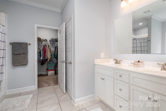 bathroom featuring crown molding, vanity, tile patterned flooring, and walk in shower