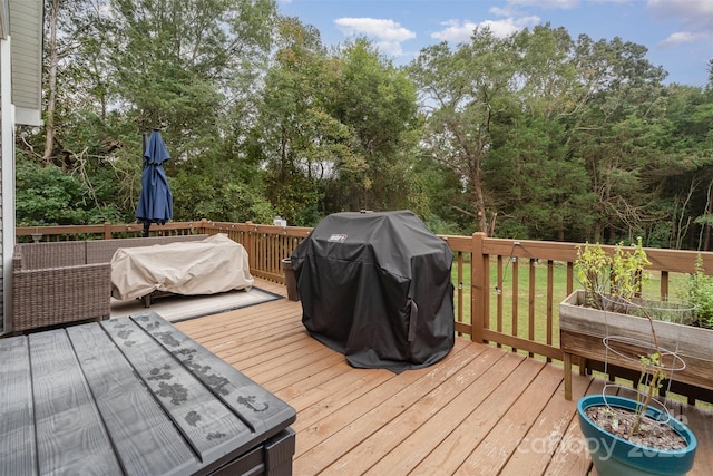 wooden deck with a grill