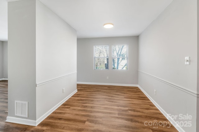 empty room with hardwood / wood-style floors