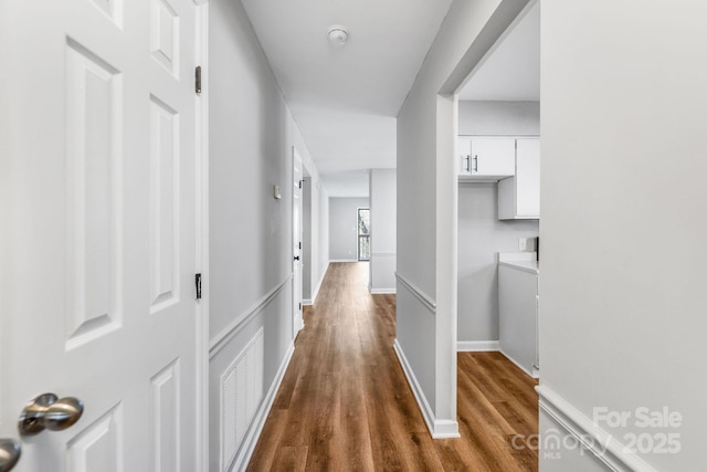 corridor featuring wood-type flooring