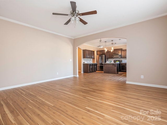 unfurnished living room with crown molding, light hardwood / wood-style flooring, and ceiling fan