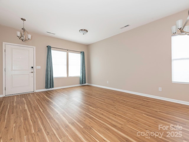 interior space featuring a chandelier and light hardwood / wood-style flooring