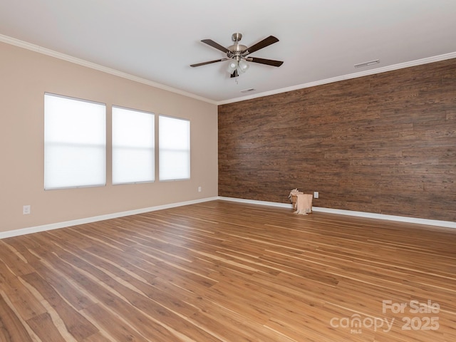 spare room featuring hardwood / wood-style flooring, crown molding, and ceiling fan