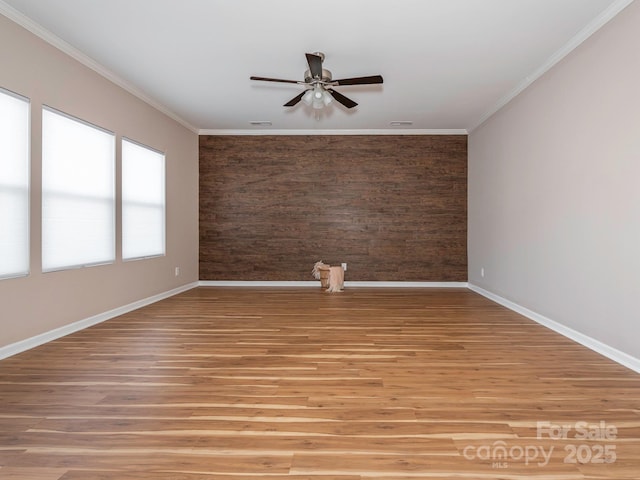 spare room featuring ornamental molding, light hardwood / wood-style floors, and ceiling fan