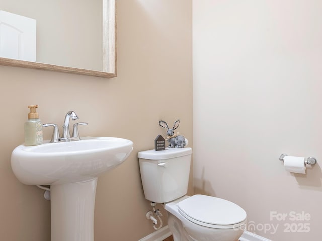 bathroom featuring sink and toilet