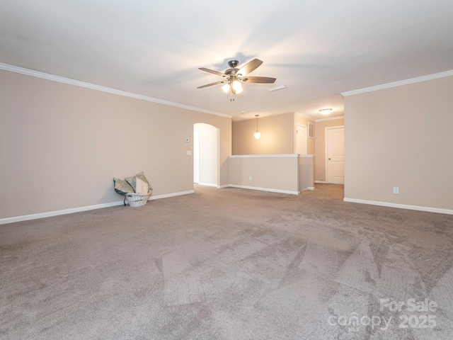 spare room featuring carpet floors, ornamental molding, and ceiling fan