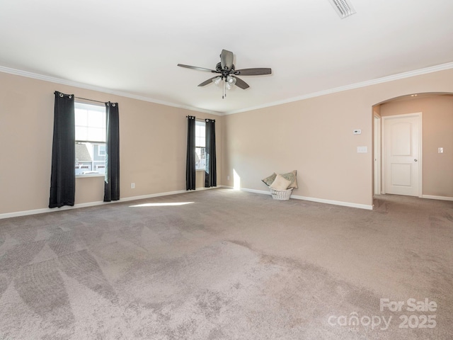 empty room with ceiling fan, light colored carpet, and ornamental molding