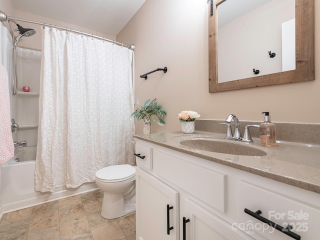 full bathroom with vanity, shower / tub combo, and toilet