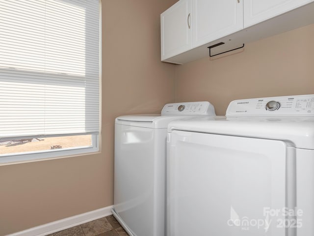 laundry area featuring washer and dryer, tile patterned flooring, and cabinets