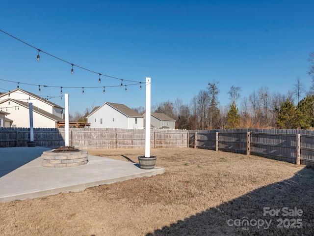 view of yard featuring an outdoor fire pit and a patio area