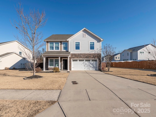 front of property with a garage and a front yard