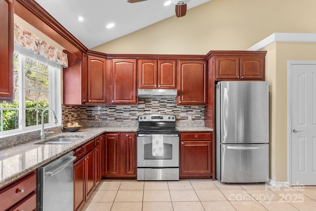 kitchen with light tile patterned floors, appliances with stainless steel finishes, extractor fan, and a sink