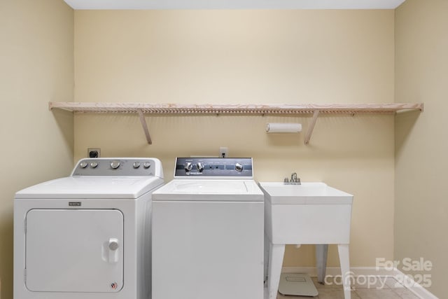 washroom featuring tile patterned flooring, laundry area, baseboards, and independent washer and dryer