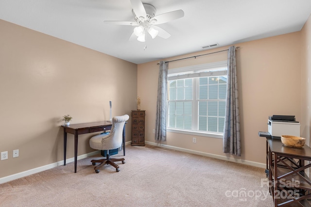 carpeted home office with visible vents, a ceiling fan, and baseboards