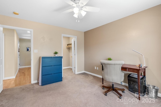 office space featuring carpet flooring, ceiling fan, and baseboards