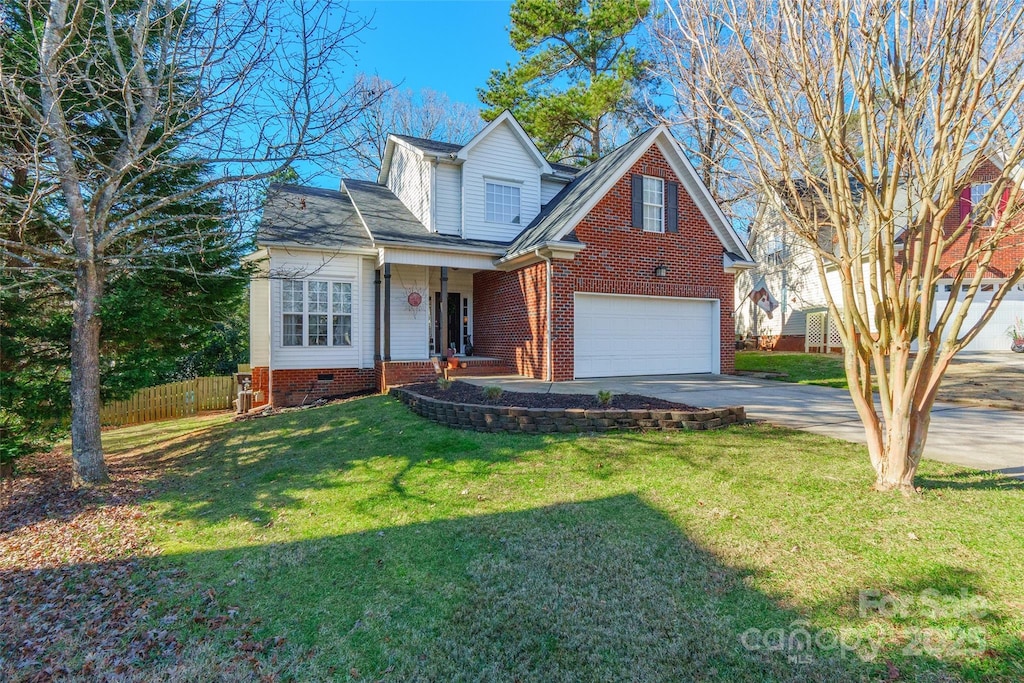 view of front of house featuring a garage and a front lawn