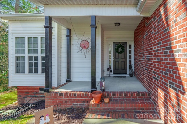 view of exterior entry with a porch