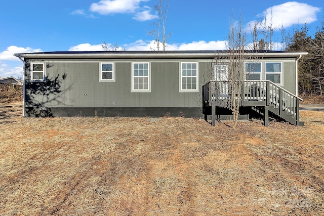 back of house featuring a wooden deck