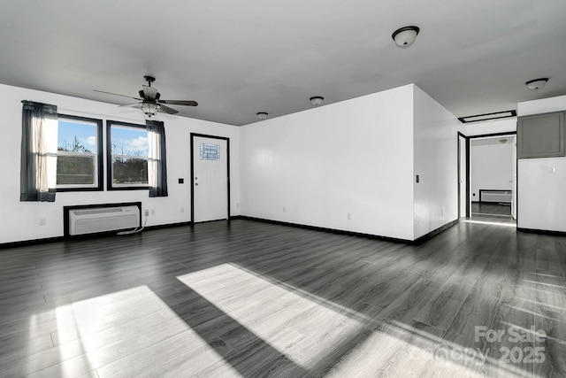 unfurnished living room featuring ceiling fan, dark wood-type flooring, a baseboard radiator, and a wall mounted AC