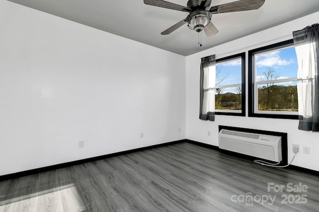 unfurnished room with ceiling fan, dark hardwood / wood-style floors, and a wall mounted AC