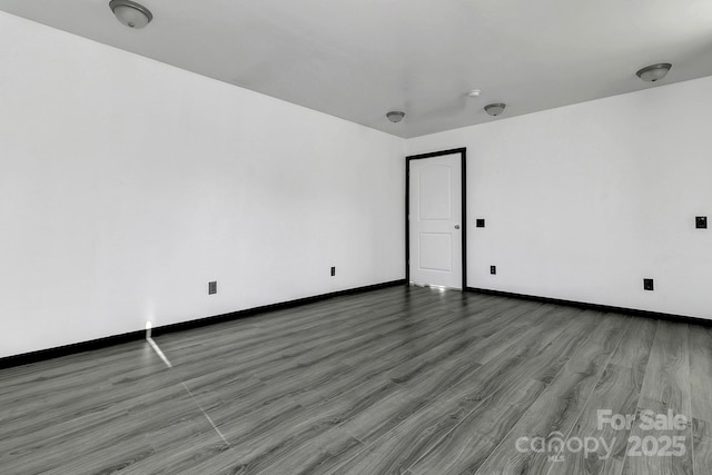 unfurnished room with hardwood / wood-style flooring