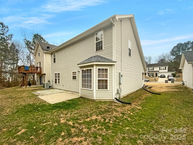 rear view of house featuring a patio, central AC, a deck, and a lawn