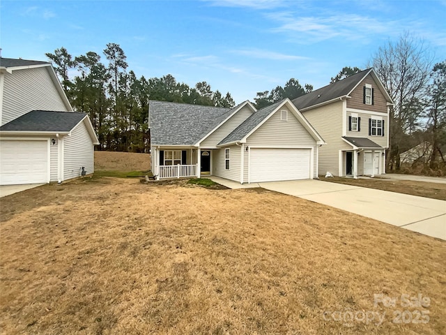 view of front property featuring a garage, a front lawn, and covered porch