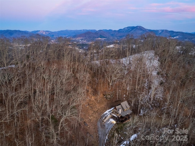 aerial view at dusk featuring a mountain view