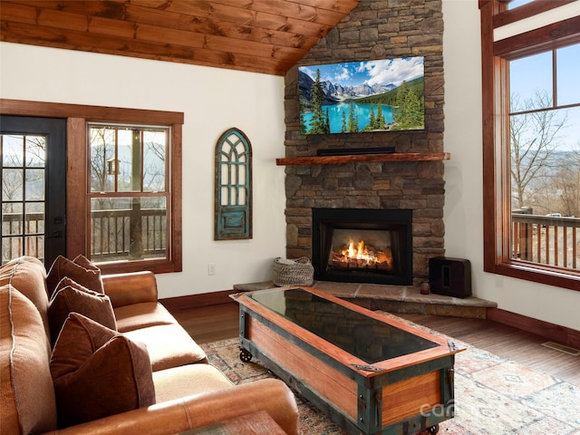 living room featuring wood-type flooring, a fireplace, vaulted ceiling, and wooden ceiling