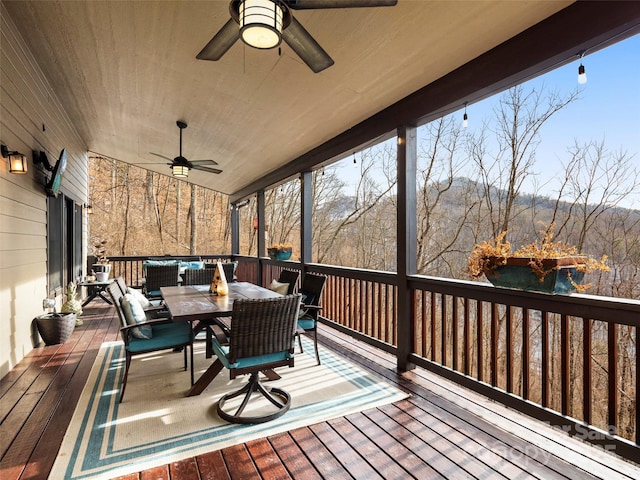 wooden deck featuring ceiling fan