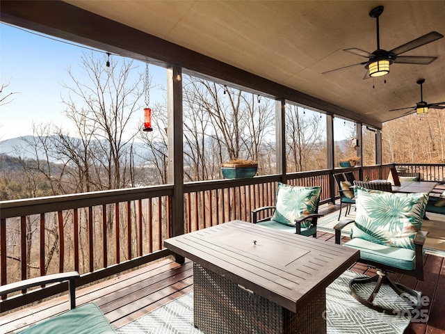 wooden terrace featuring ceiling fan