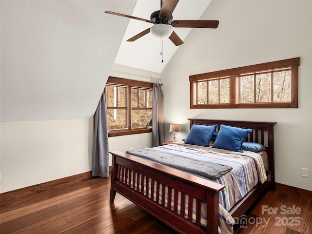 bedroom featuring lofted ceiling, dark hardwood / wood-style flooring, and ceiling fan