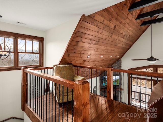 interior space with wood ceiling, lofted ceiling with beams, and hardwood / wood-style flooring