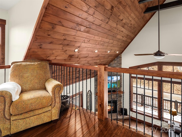 living area featuring ceiling fan, lofted ceiling, hardwood / wood-style floors, and wood ceiling