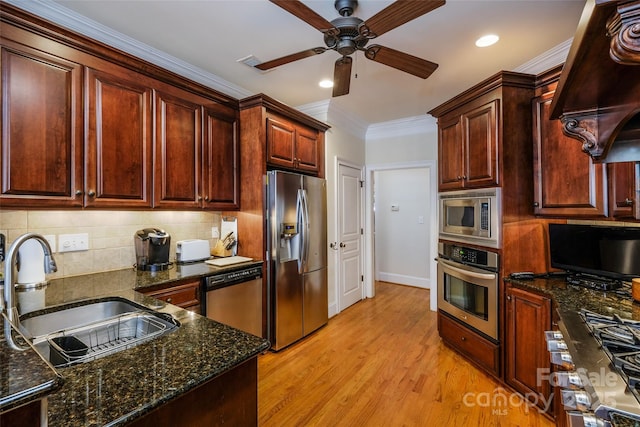 kitchen featuring sink, custom exhaust hood, stainless steel appliances, crown molding, and light wood-type flooring