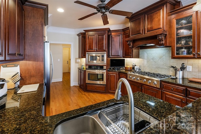 kitchen with sink, appliances with stainless steel finishes, tasteful backsplash, ornamental molding, and light hardwood / wood-style floors