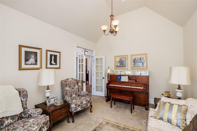 sitting room with light carpet, high vaulted ceiling, french doors, and a chandelier