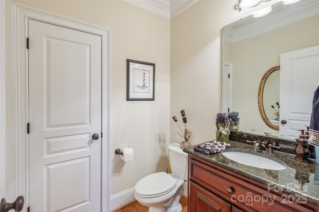 bathroom featuring ornamental molding, toilet, and vanity