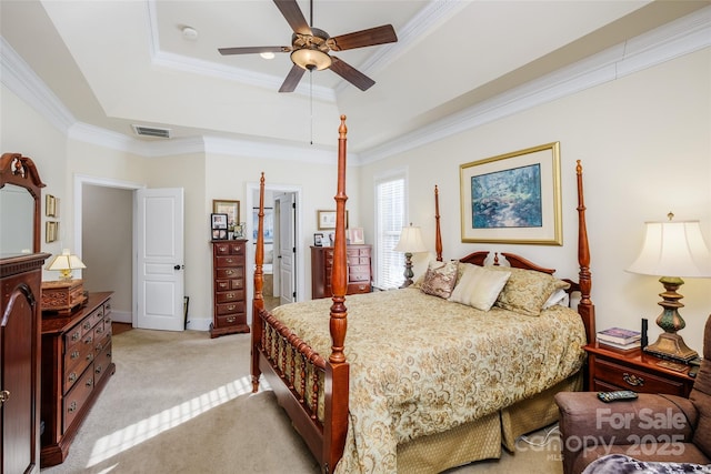 carpeted bedroom featuring crown molding, ceiling fan, and a tray ceiling